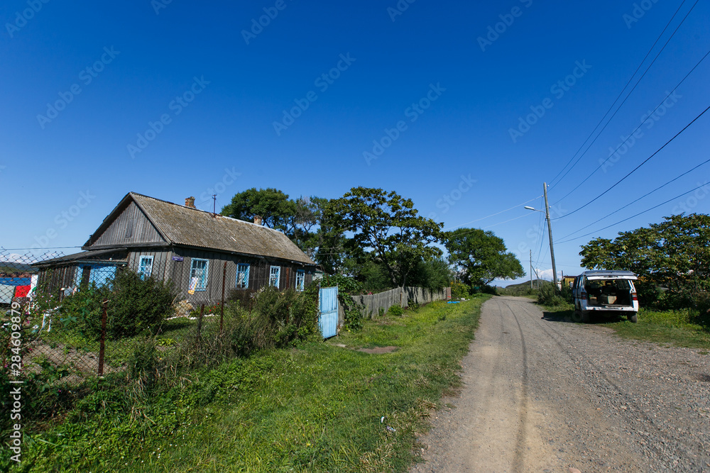 Wooden village house in the summer garden