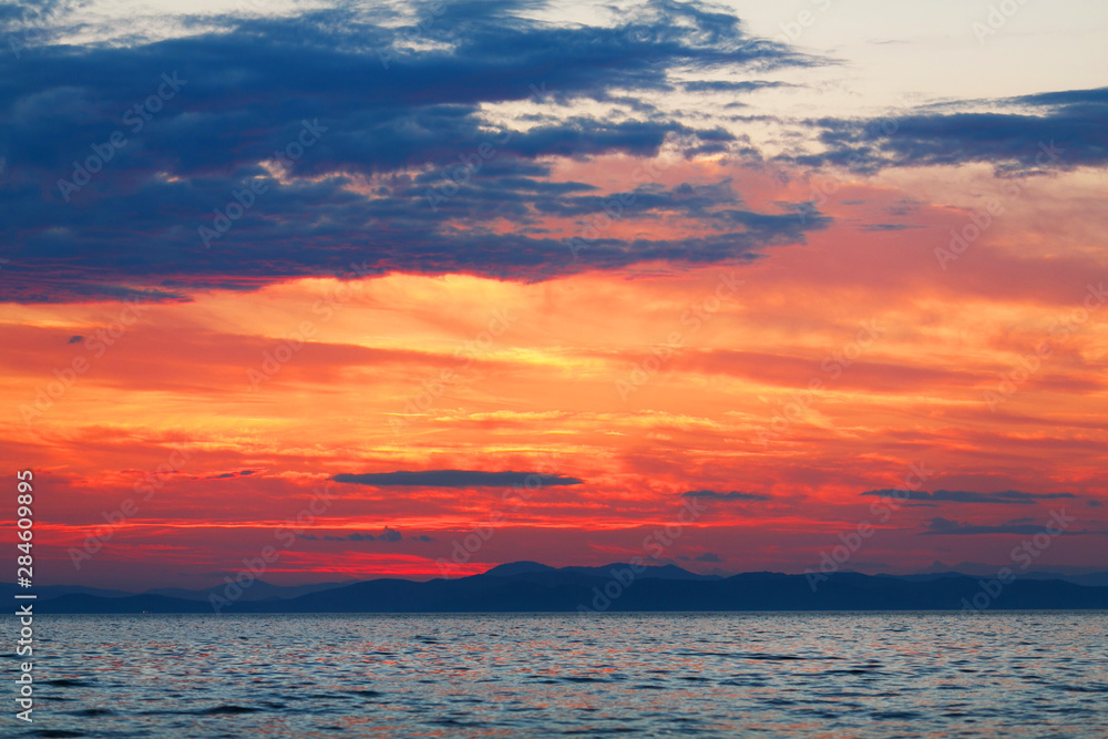 Beautiful sea sunset. Colored sunset on the sea.