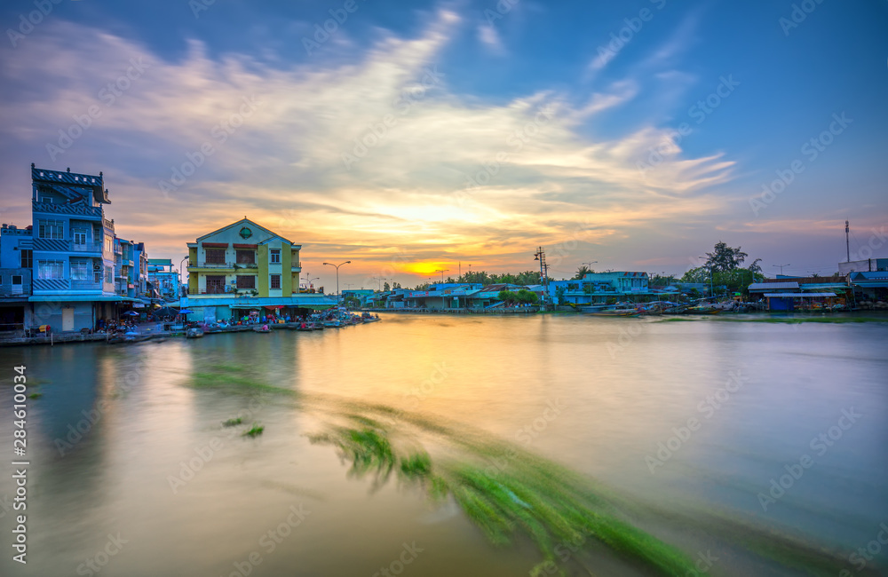 Sunset landscape on the beautiful riverbank the Mekong Delta in Soc Trang, Vietnam