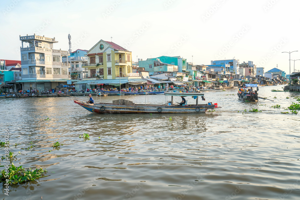 Ferry woman rowing takes visitors or agricultural products across river floating market , this is main transportation Lunar New Year in Soc Trang, Vietnam