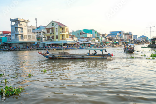 Ferry woman rowing takes visitors or agricultural products across river floating market , this is main transportation Lunar New Year in Soc Trang, Vietnam
