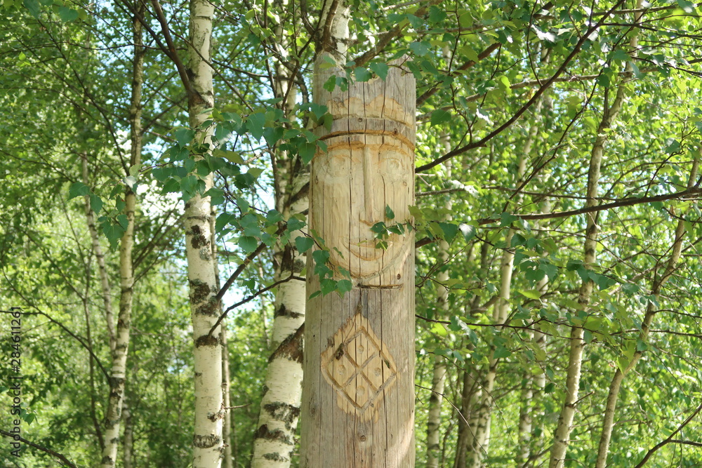 Fototapeta premium Ancient wooden slavic pagan idol of god. Heathen temple in the forest