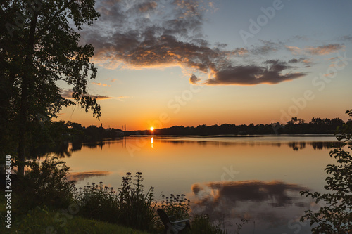 The orange light of a beautiful sunset is reflected in the eagle creek at Marinette,WI. © Shubby Studio