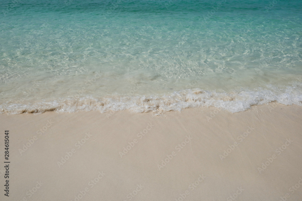 crystal clear Andaman blue sea with white waving and smooth sand beach in bright daylight crystal clear Andaman blue sea with white waving and smooth sand beach in bright daylight