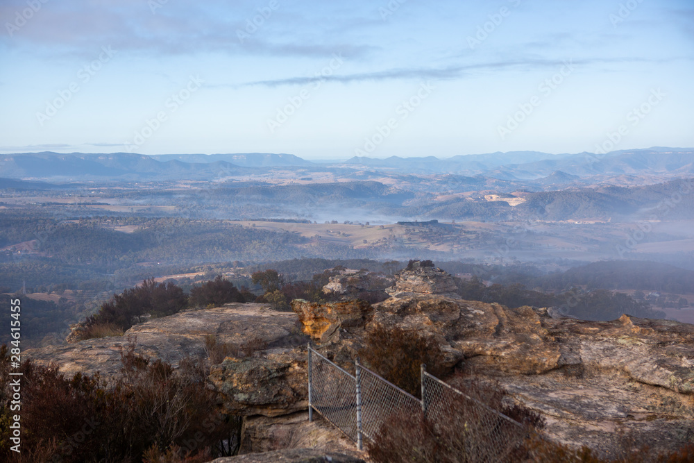 The view of surrounding mountains and fog in the valleys looking from Hassans Walls Lithgow new South Wales Australia on 31st July 2019