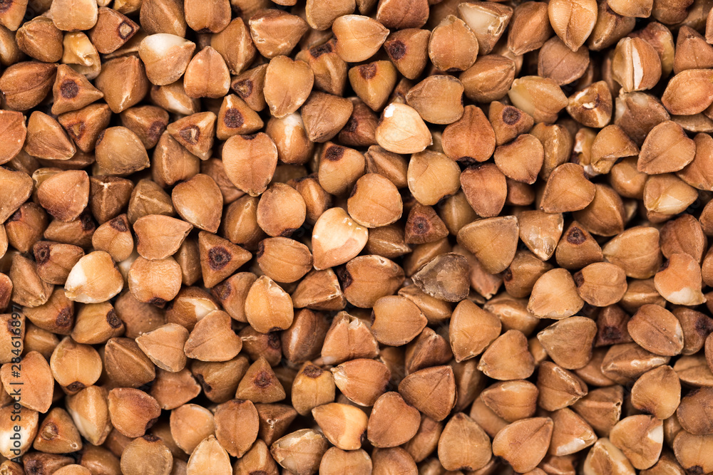 Macro Photo food buckwheat groats. Texture background grain buckwheat groats. Image food product porridge buckwheat grains Macro Photo food buckwheat groats. Texture background grain buckwheat groats. Image food product porridge buckwheat grains