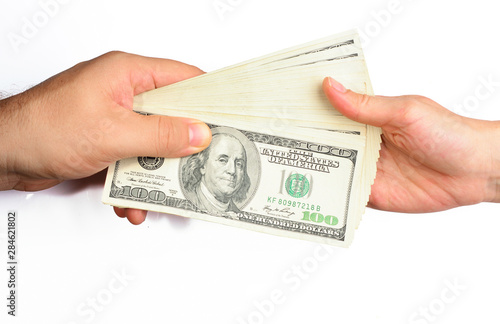 Man giving dollar bills to a woman on a white background. Close-up