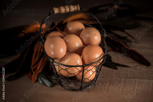 Fresh eggs in a basket on wooden table