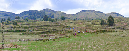 Beautiful andean landscape. Panoramic photo. Mountains, valley and people working.