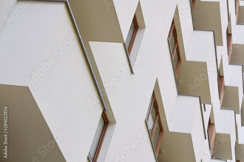 Modern apartment building outside in daytime. balcony in modern house, facade of modern apartment building. strict repeating geometry