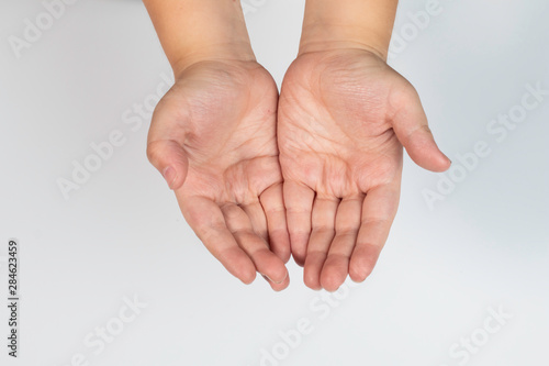 Top view flat lay outstretched little Asian boy hands on white isolated background