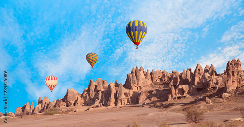 Hot air balloon flying over rock landscape - Cappadocia, 