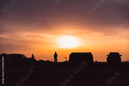 Silhouette of a man standing in a camping site
