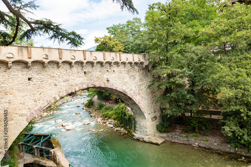 View of the famous Steinerner Steg / Ponte Romano bridge, a two-arched, stone-built footbridge across the Passer in Merano, South Tyrol, northern Italy photo