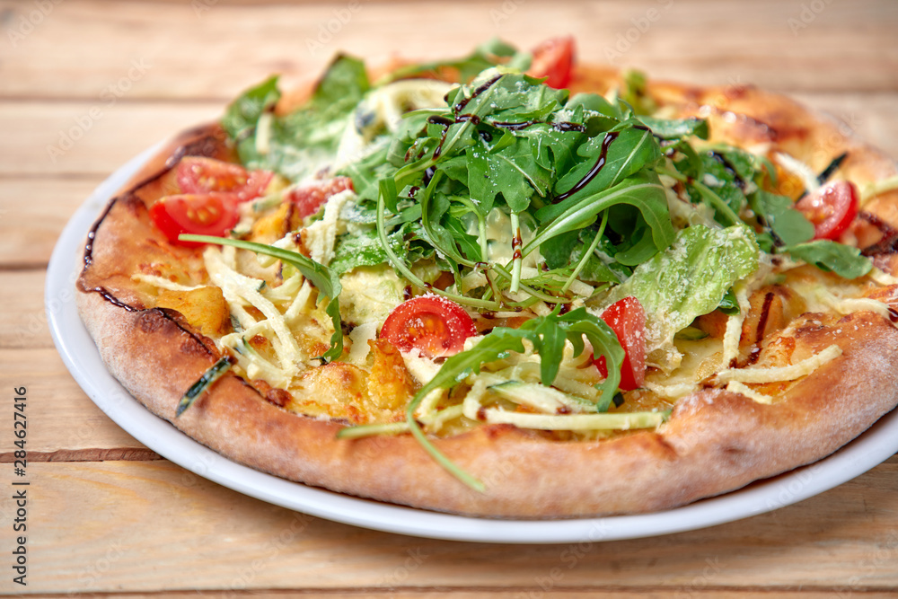 pizza with fresh vegetables on the wooden background pizza with fresh vegetables on the wooden background