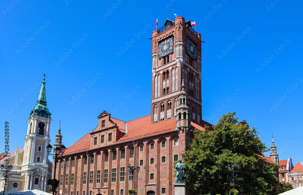 The Gothic Old Town Hall (Ratusz Staromiejski), Holy Spirit Church and Copernicus monument in Torun, Poland. August 2019