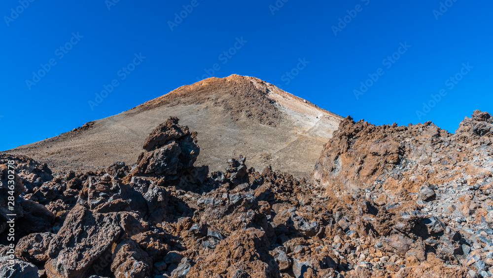 Lava fields on the background of the top of the volcano Teide