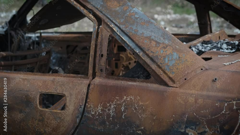 Car at the dump. An old burnt-out abandoned car in a landfill. Car at the dump. An old burnt-out abandoned car in a landfill.