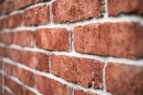 red brick wall texture grunge background with vignetted corners.