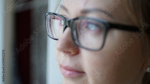 Shot close-up of glasses on a beautiful woman with blurred face
