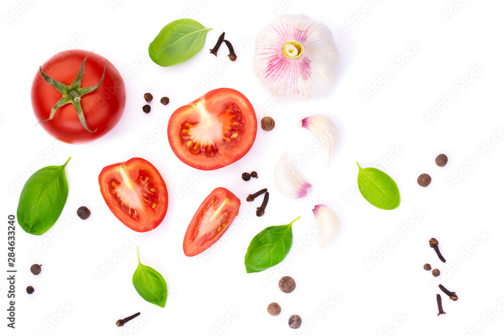 top view of whole and sliced tomato with basil leaves and garlic, spice, isolated on white background top view of whole and sliced tomato with basil leaves and garlic, spice, isolated on white background