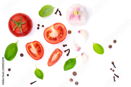 Fototapeta Naklejka Na Ścianę i Meble -  top view of whole and sliced ​​tomato with basil leaves and garlic, spice, isolated on white background