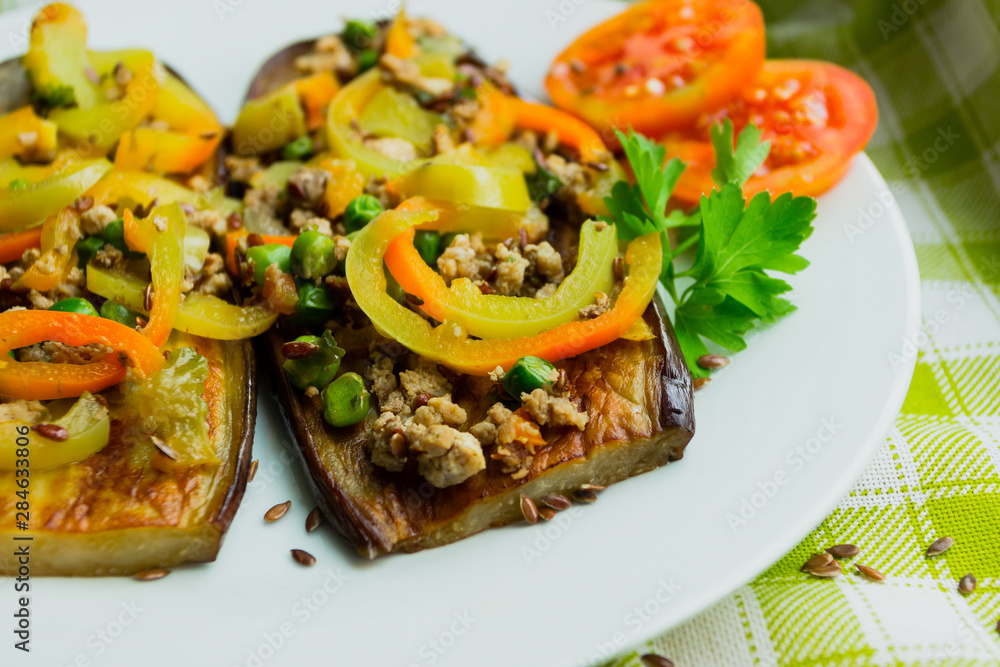 Fried eggplants with minced meat and different vegetables, flaxseed decoration, finished dish Fried eggplants with minced meat and different vegetables, flaxseed decoration, finished dish