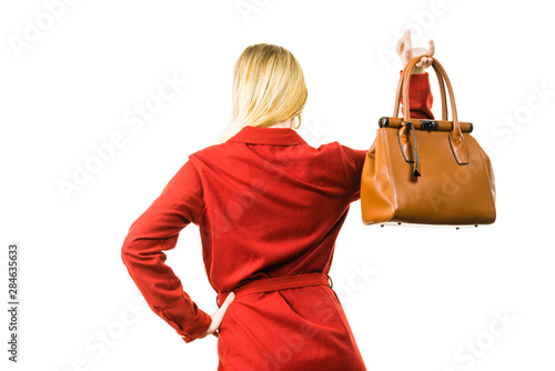 Female wearing red dress holding bag