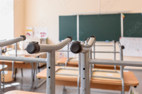 Empty classroom with inverted chairs on desks at the end of school lessons