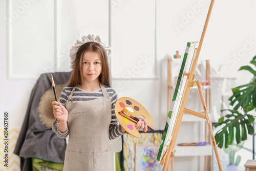 Cute little artist in studio