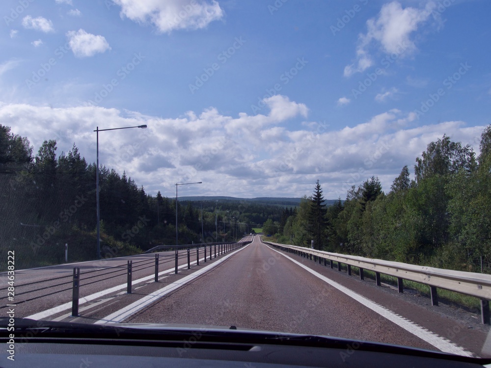 road in Sweden, cloudy sky background