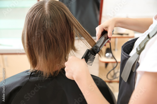 Female hairdresser working with client in salon, closeup © Pixel-Shot