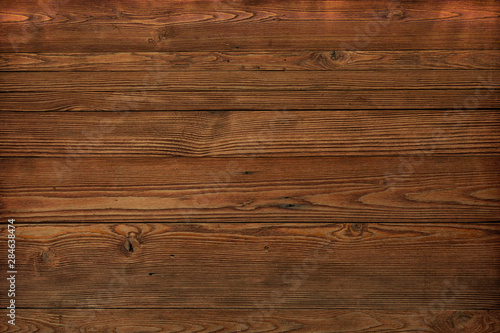 Brown wooden plank desk table background texture. Top view.