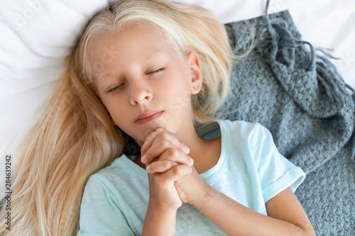 Little girl praying at home