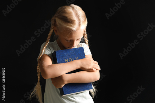 Little girl with Bible on d...