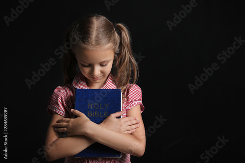Cute little girl with Bible...