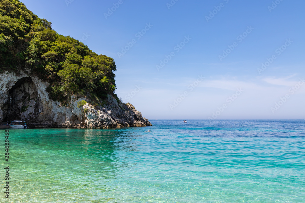 Rovinia beach in Liapades. One of greek island Corfu natural beach view with crystal clear water. Corfu, Greece.
