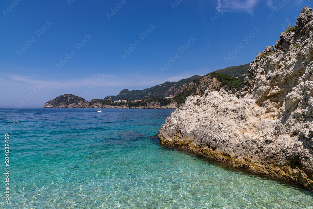 Rovinia beach in Liapades. One of greek island Corfu natural beach view with crystal clear water. Corfu, Greece.