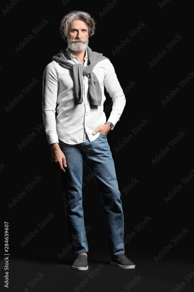 Fashionable senior man on dark background Fashionable senior man on dark background