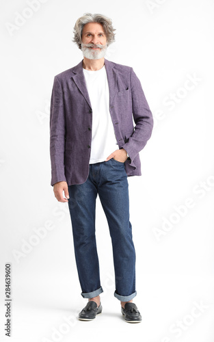 Fashionable senior man on light background