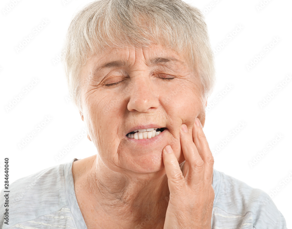 Senior woman suffering from toothache against white background Senior woman suffering from toothache against white background