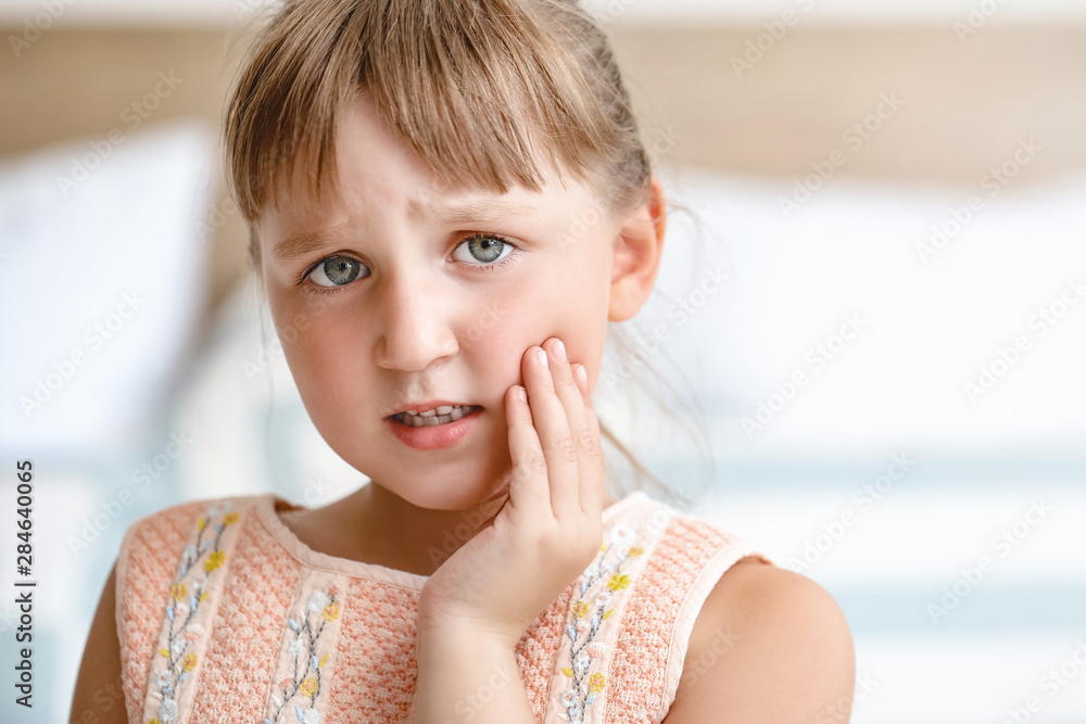 Little girl suffering from toothache at home Little girl suffering from toothache at home