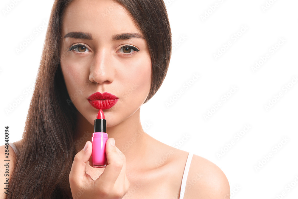 Beautiful young woman with lipstick on white background Beautiful young woman with lipstick on white background