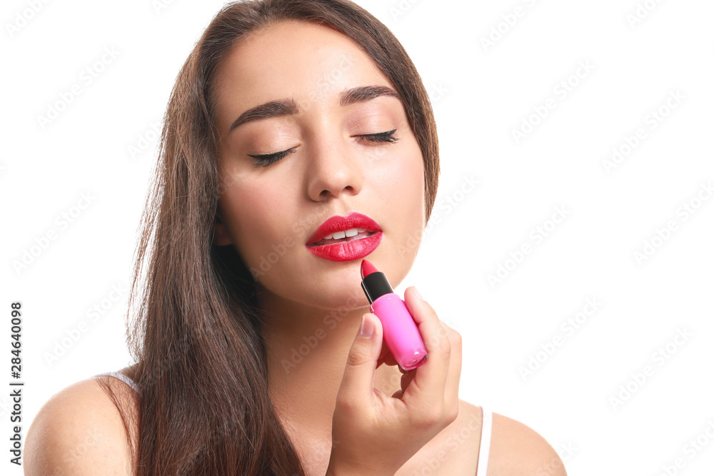 Beautiful young woman with lipstick on white background Beautiful young woman with lipstick on white background