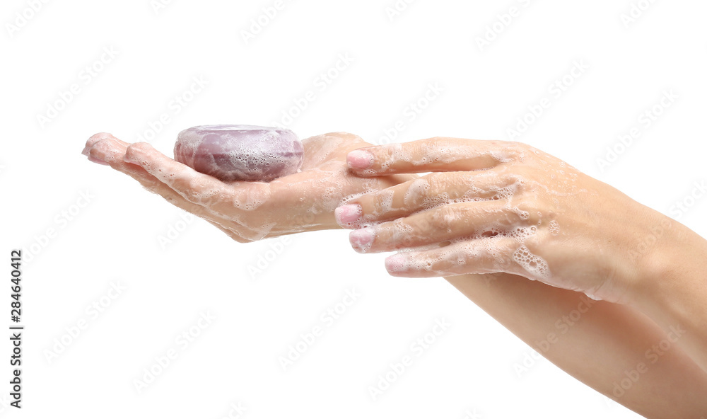 Fototapeta premium Female hands with soap on white background