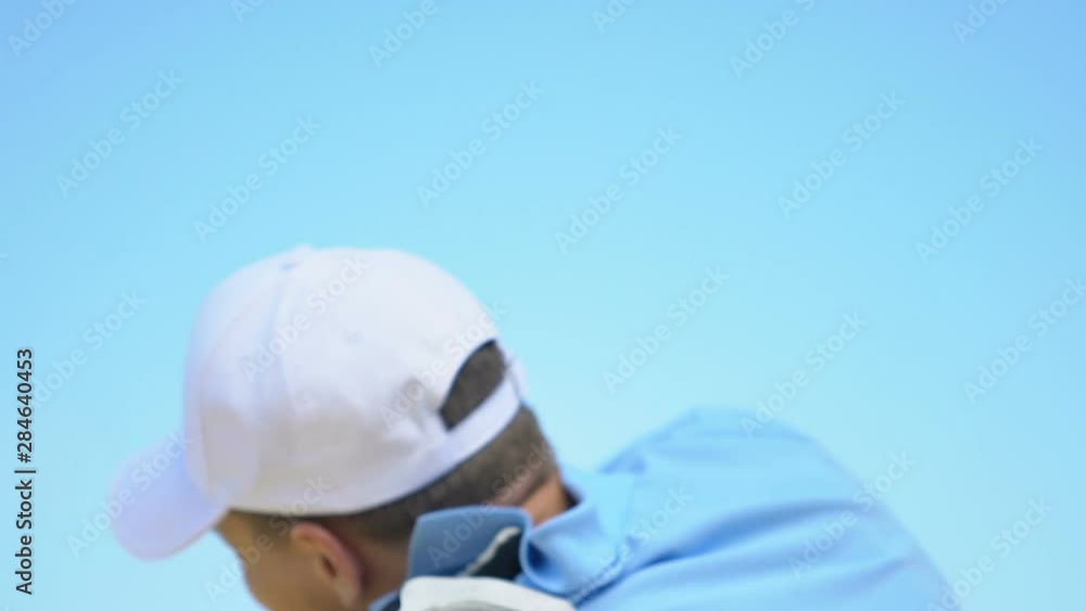 Man golfer making shot and feeling sudden pain in shoulder, muscles tension Man golfer making shot and feeling sudden pain in shoulder, muscles tension