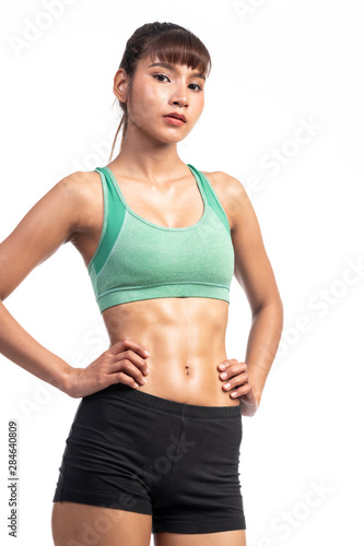 Fitness woman white background. Asian woman. Hands on hip, looking confident. © Baan Taksin Studio