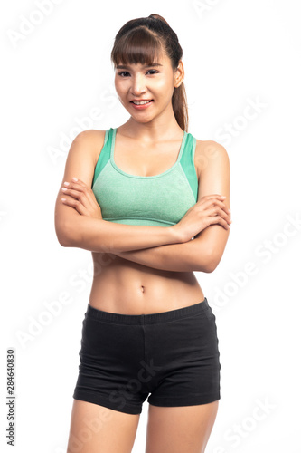 Fitness woman white background. Asian woman. Arm cross, happy smile. © Baan Taksin Studio