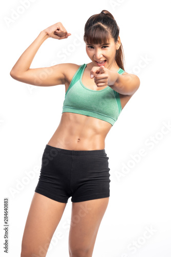 Fitness woman white background. Asian woman. Point finger, fitness motivation. © Baan Taksin Studio