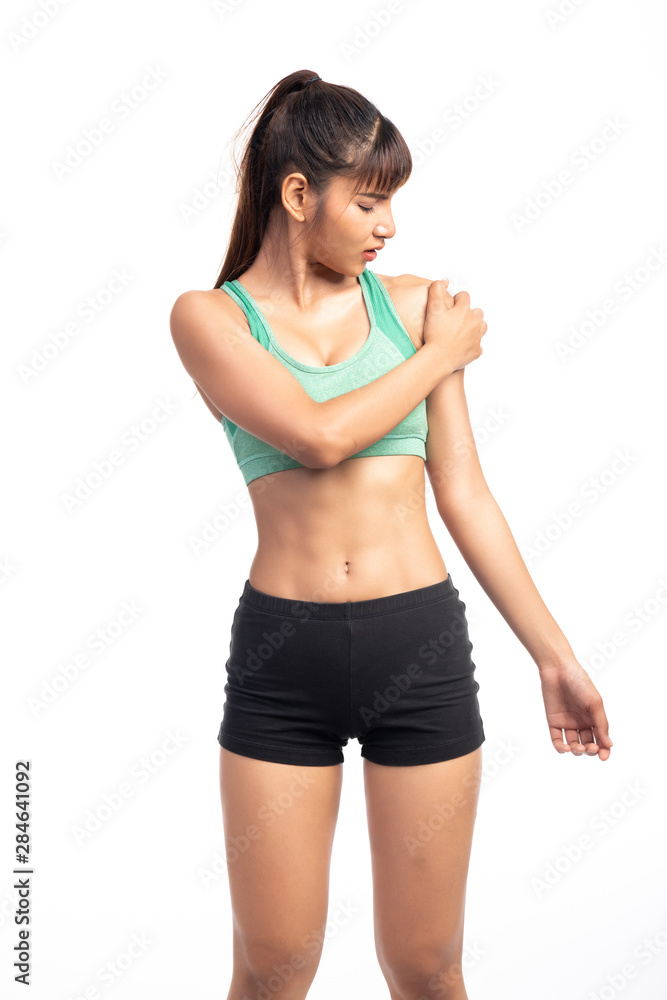Fitness woman in pain. Asian girl, rubbing her shoulder. Fitness woman in pain. Asian girl, rubbing her shoulder.